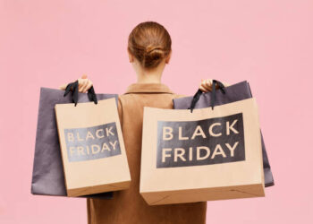 Carrying black Friday paperbags