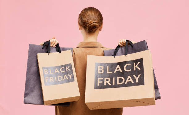 Carrying black Friday paperbags